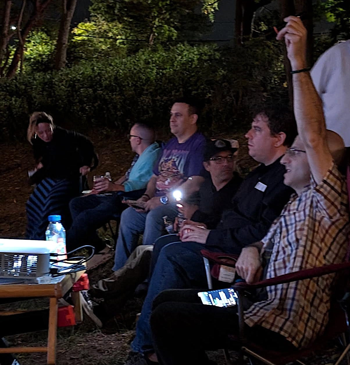 Audience sitting behind the projector at the Manahattan Short film festival at Eastman Cottage